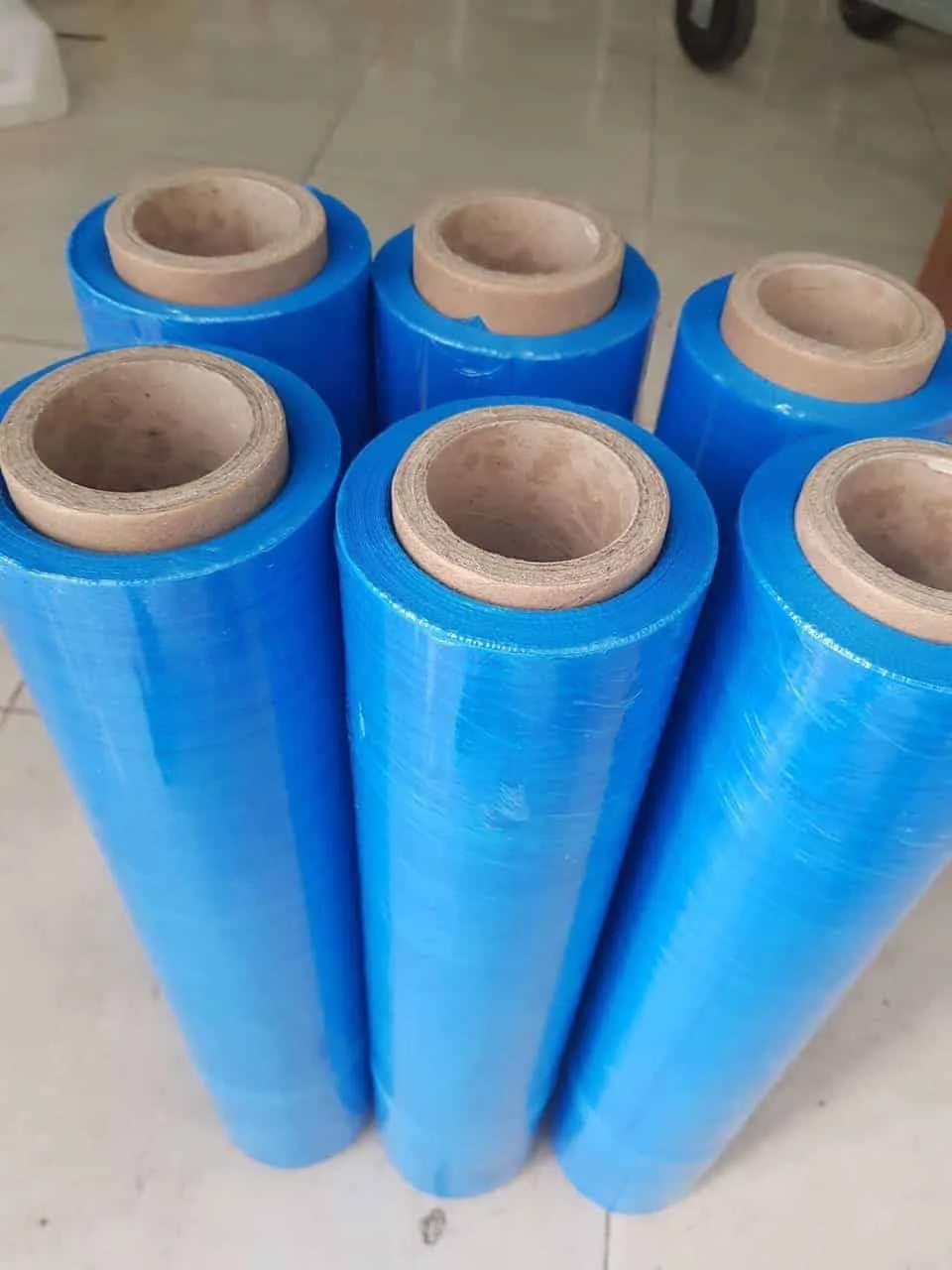 Blue PE hand stretch film rolls on paper cores