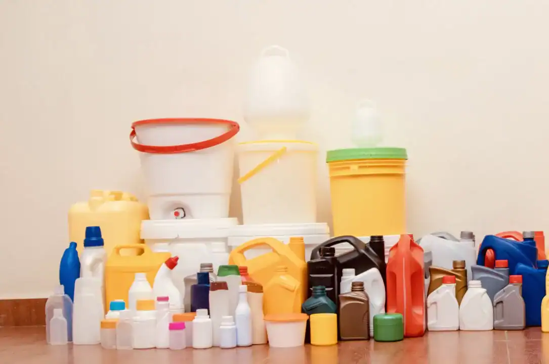 Multicolored plastic jerrycans, bottles and buckets holding food and chemicals