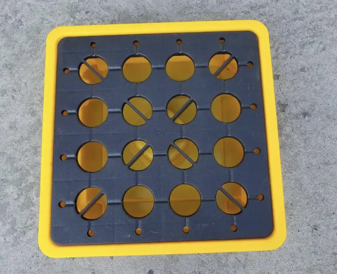 Top view of a single-drum spill pallet with a yellow tray and a black grated deck with drain openings