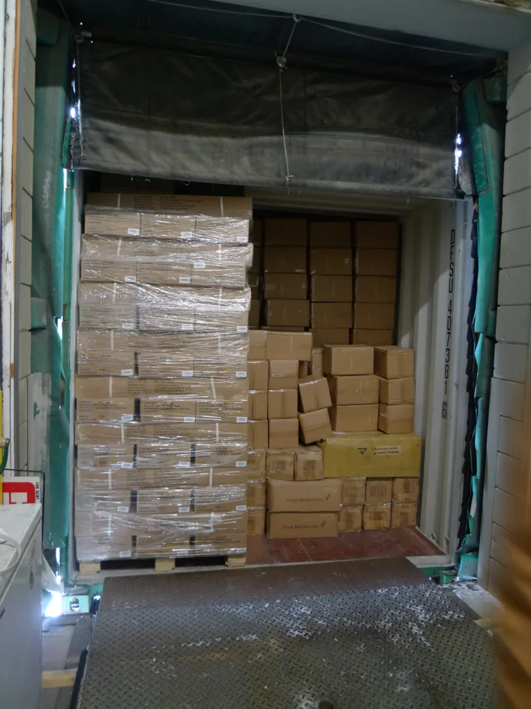 Boxed goods stacked on pallets inside a container