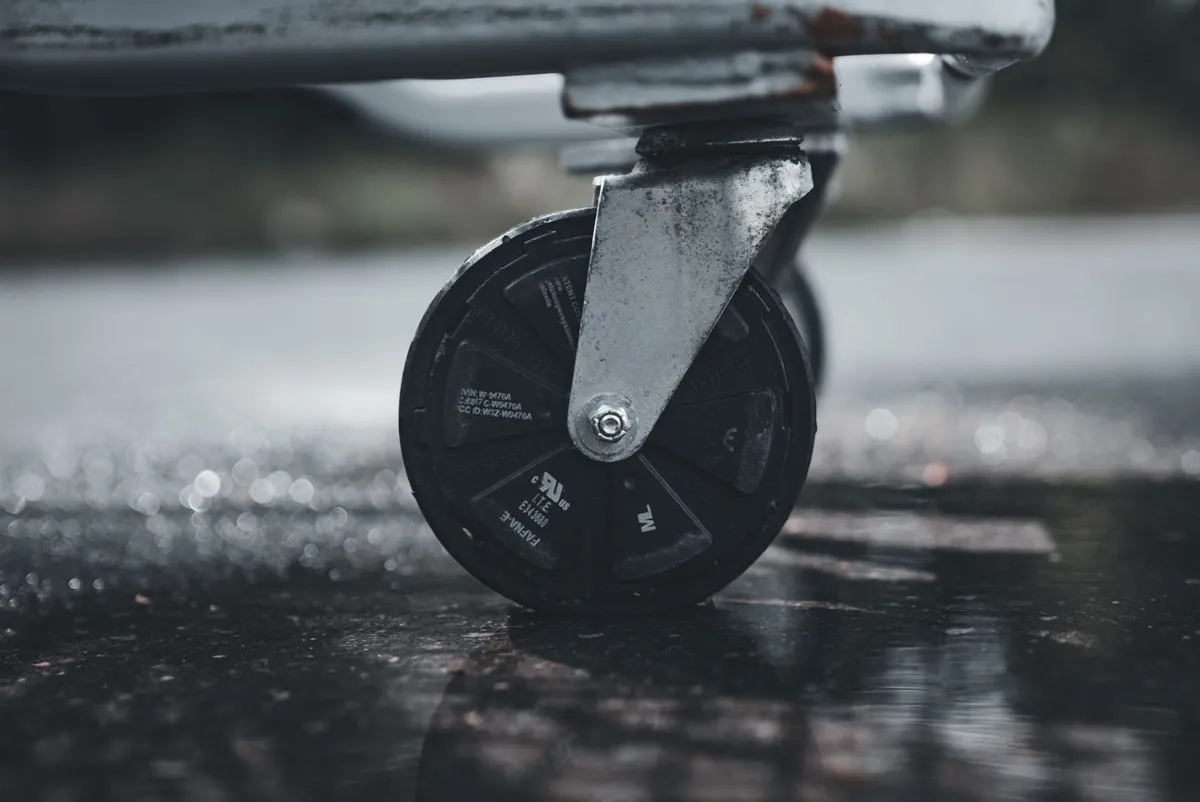 Industrial swivel caster with a plastic tread on a wet floor