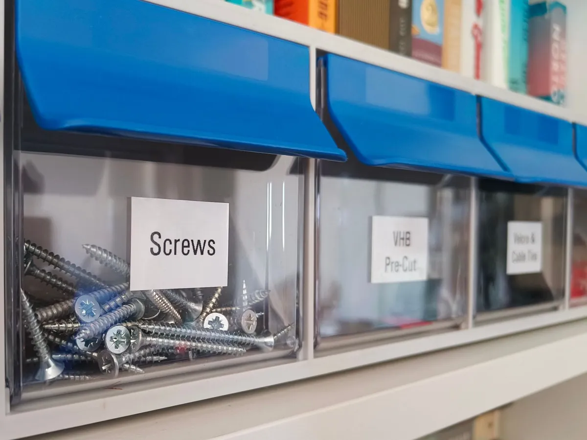 Plastic tray sorting screws into labeled compartments at the front