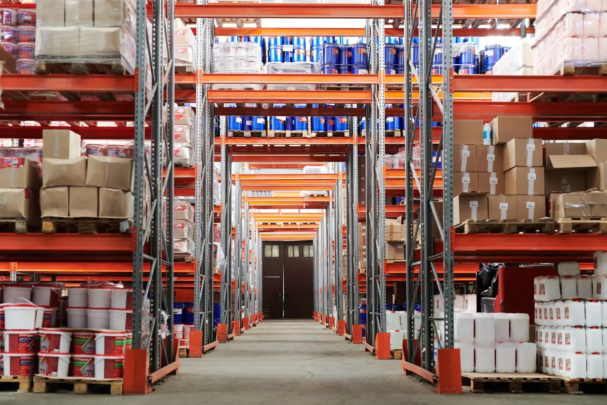 Aisle between rows of multi-level racking holding palletised goods