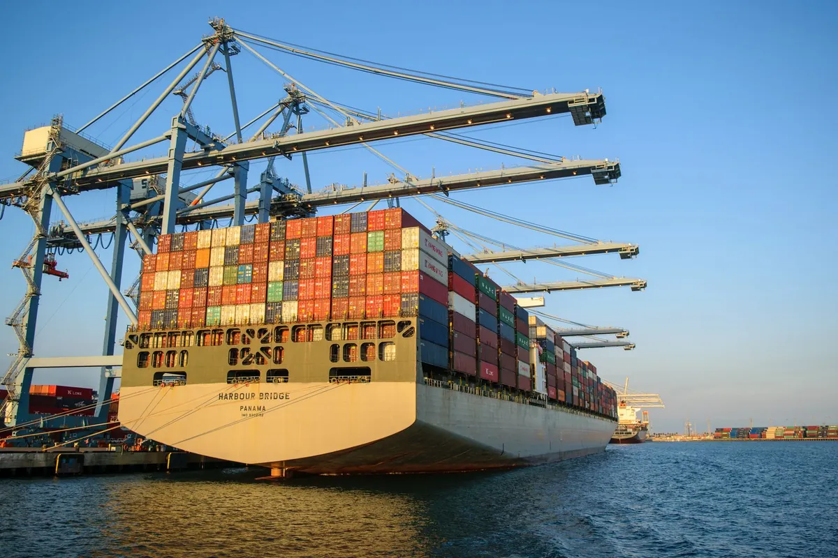 Container ship at a seaport, export goods travelling on pallets in the container
